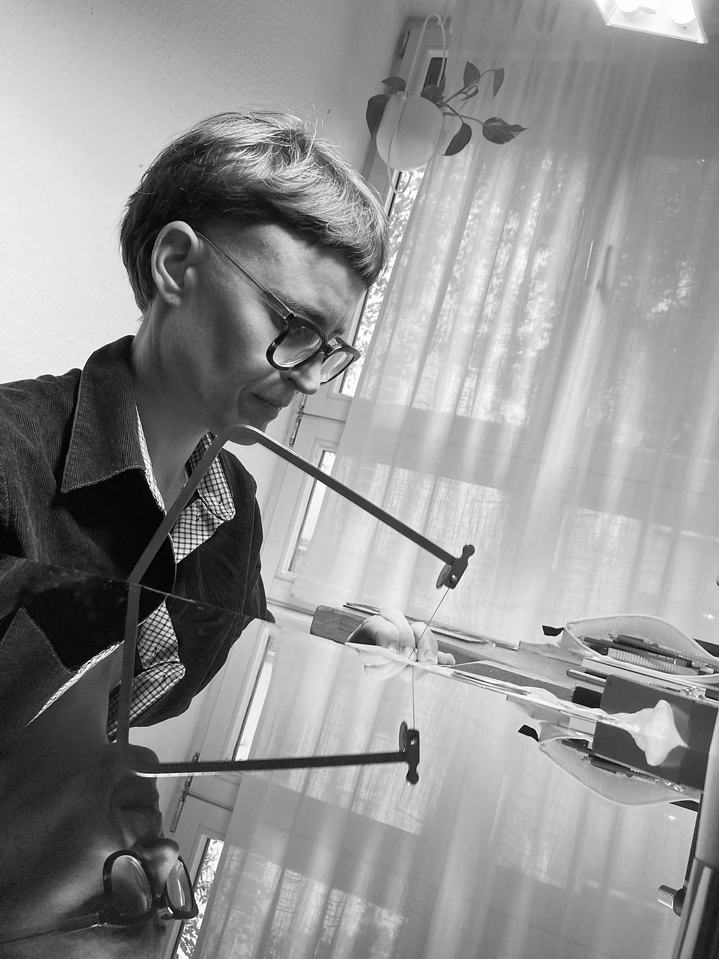 Kristina Wedde sawing at her workbench
