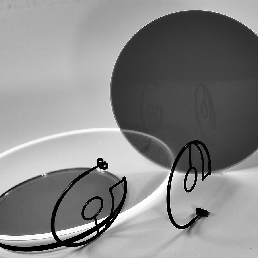 Black wire hoop earrings with a small circle, black and white photo