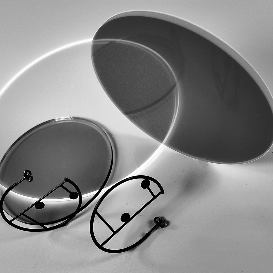 Pair of black wire hoop earrings with two dots, on acrylic discs