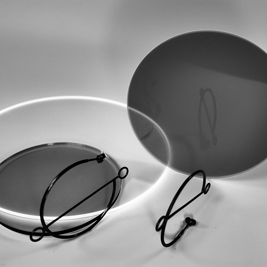Black wire hoop earrings with open circles and a diagonal line