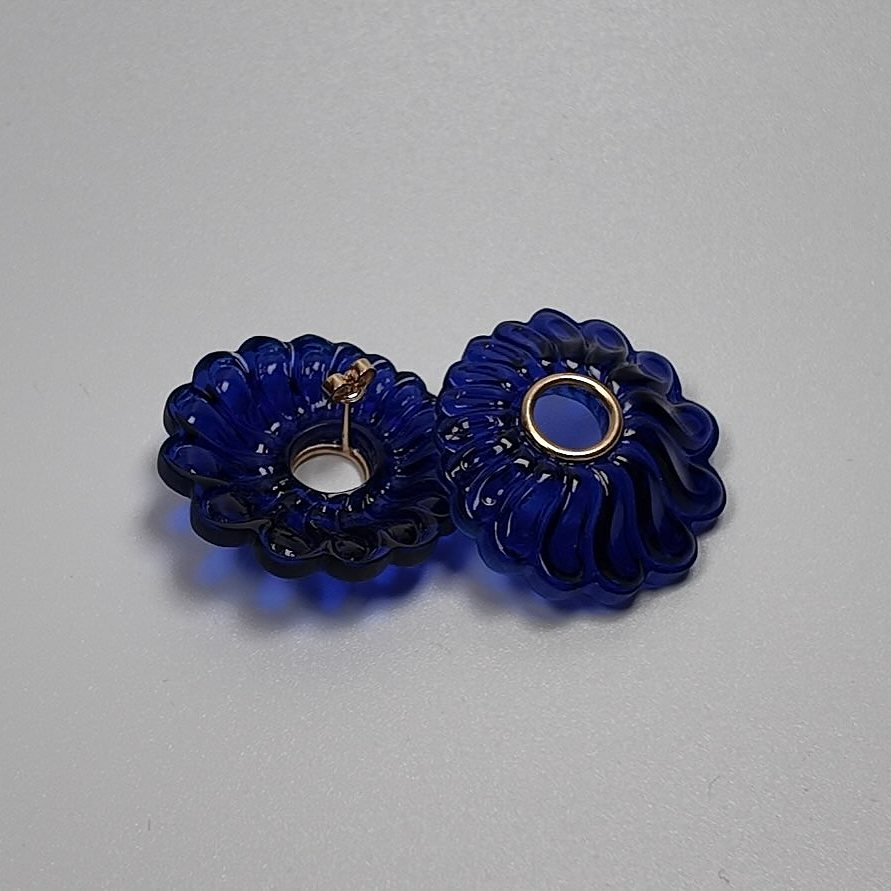 Dark blue acrylic flower-shaped stud earrings with gold-plated silver, another angle