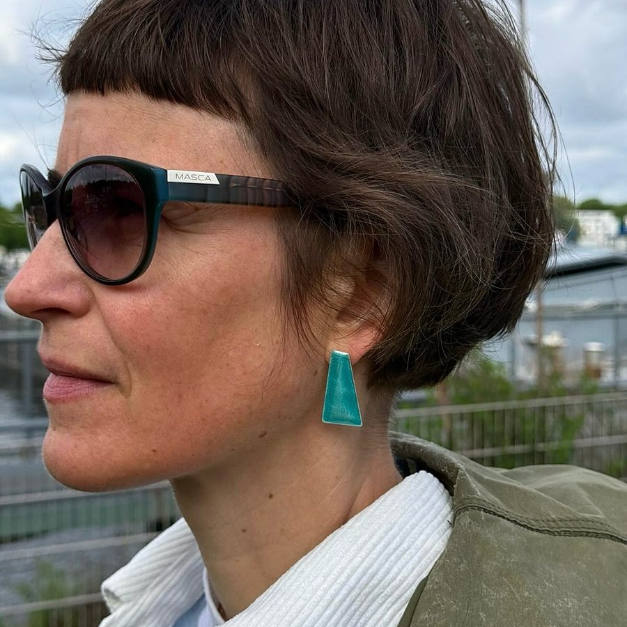 Portrait with a petrol enamel trapezoid stud earring
